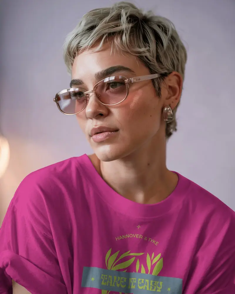 Fashionable T Shirt Mockup Featuring A Female Model With A Chic Hairdo And Elegant Eyewear Under Pastel Hues