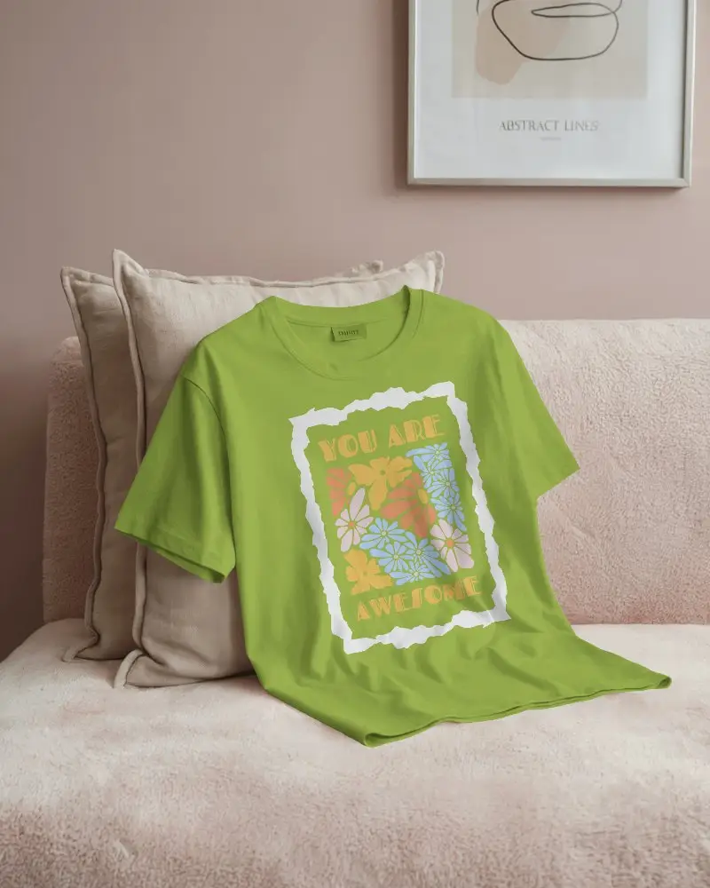 Pastel Themed Flat Display T Shirt Mockup On Fluffy Couch With Neutral Pillows For Luxury Loungewear Campaigns
