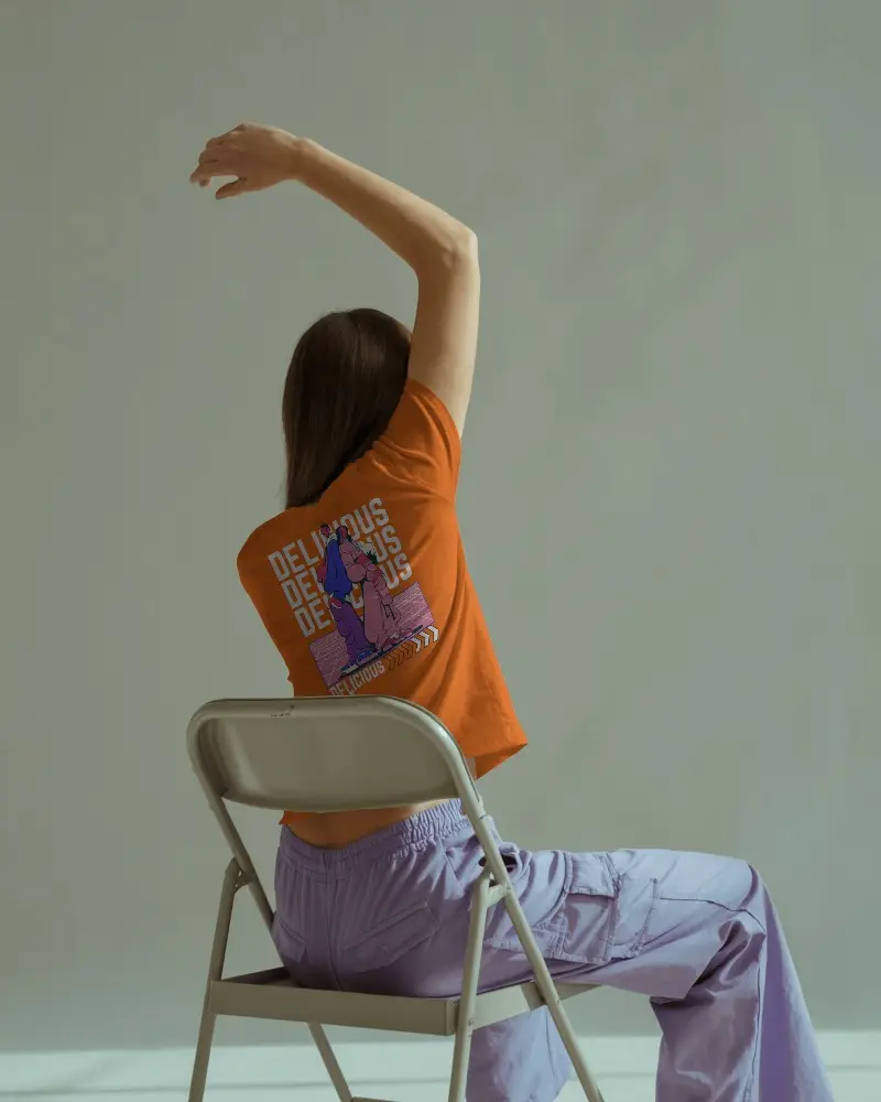 Seated Urban Style Tshirt Mockup With Back Facing Model In Casual Pose Showing Back Design On Modern Fit