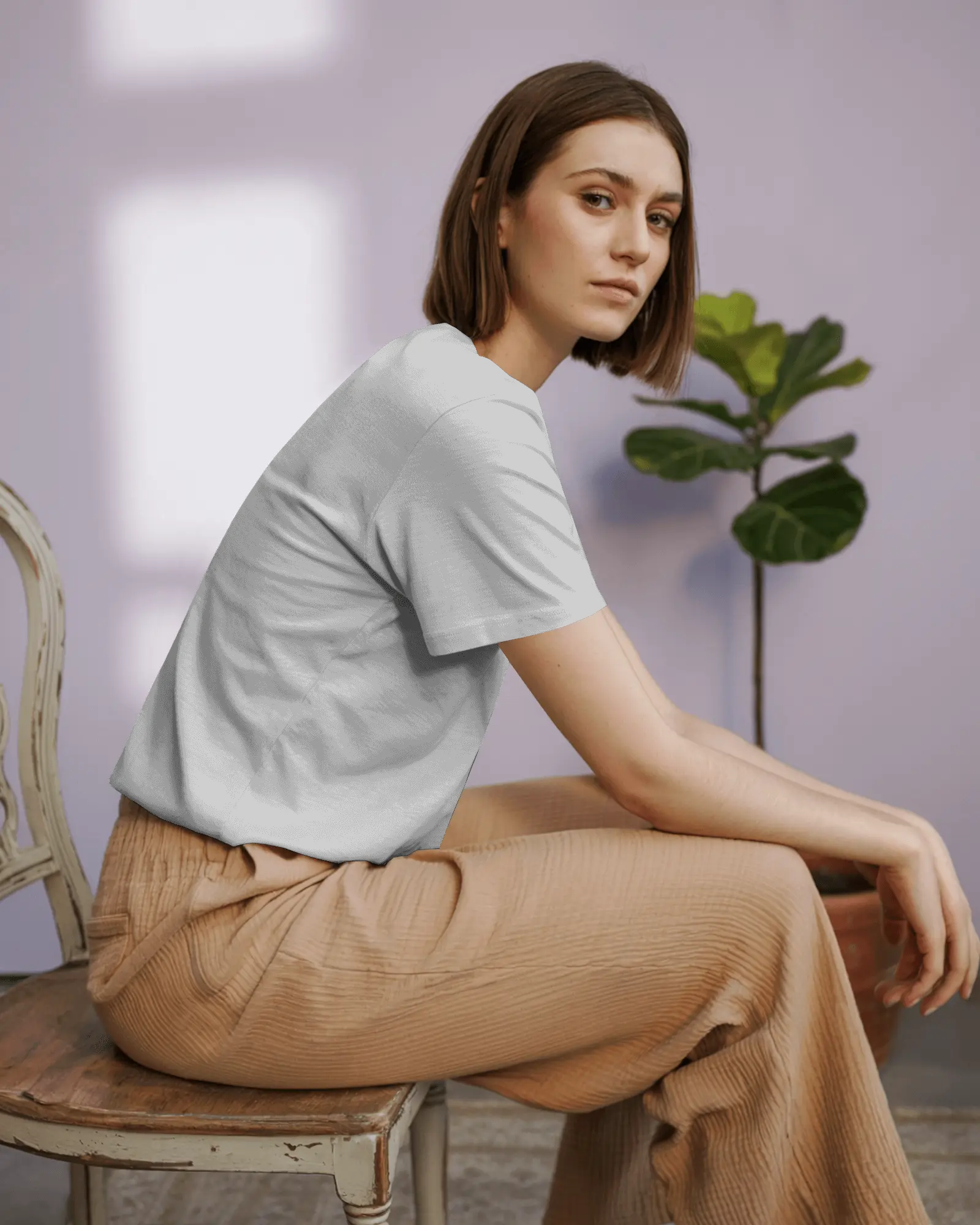 Editorial Lookbook Tshirt Mockup Side View Female Model On Vintage Chair In Modern Soft Lighting