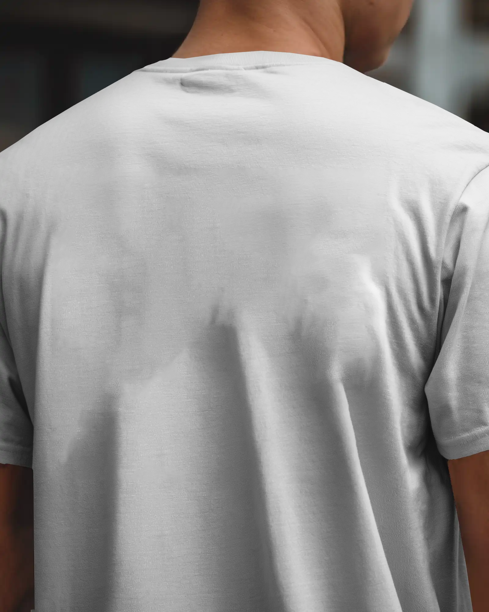 White Tshirt Mockup Closeup Back View Male Model Outdoor Setting Natural Lighting Bold Design Focus