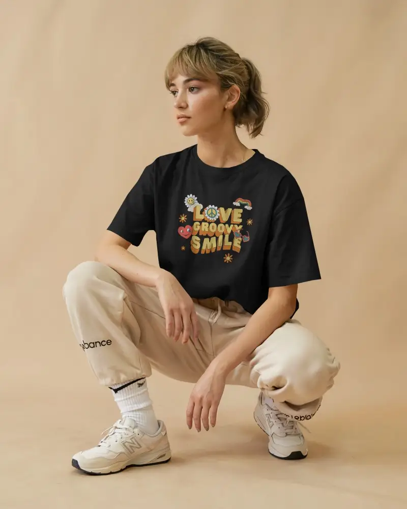 White Tshirt Mockup Female Model Crouching Beige Joggers Neutral Backdrop Streetwear Style Relaxed Athleisure Aesthetic