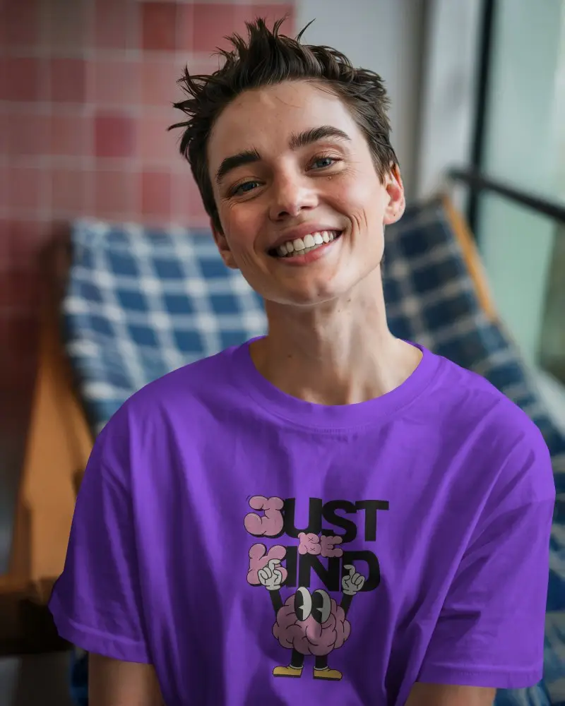 Sunny Window Seating T Shirt Mockup Smiling Model Sitting On Wooden Chair Relaxed And Warm Atmosphere Casual Interior