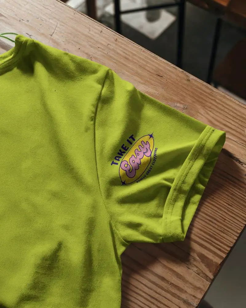 Natural Light Closeup T Shirt Mockup Sleeve Design On Wooden Table In Warm Daylight Studio Floor Setting