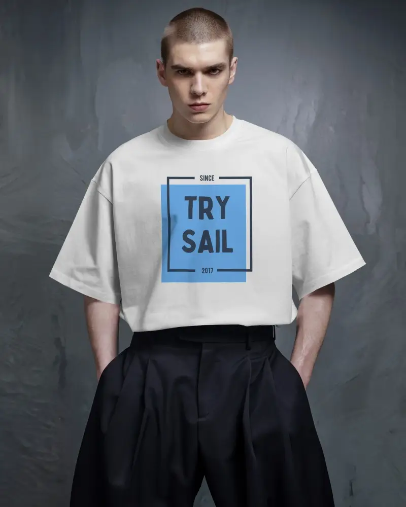 Moody Studio T Shirt Mockup Male Model With Buzzcut In High Fashion Pose Against Textured Dark Grey Background