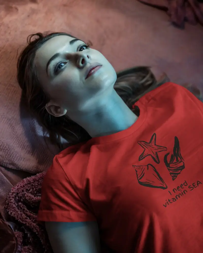 Moody Bedroom Tshirt Mockup Female Model Lying On Textured Bedding With Soft Blue And Pink Lighting Dreamy And Contemplative Vibe