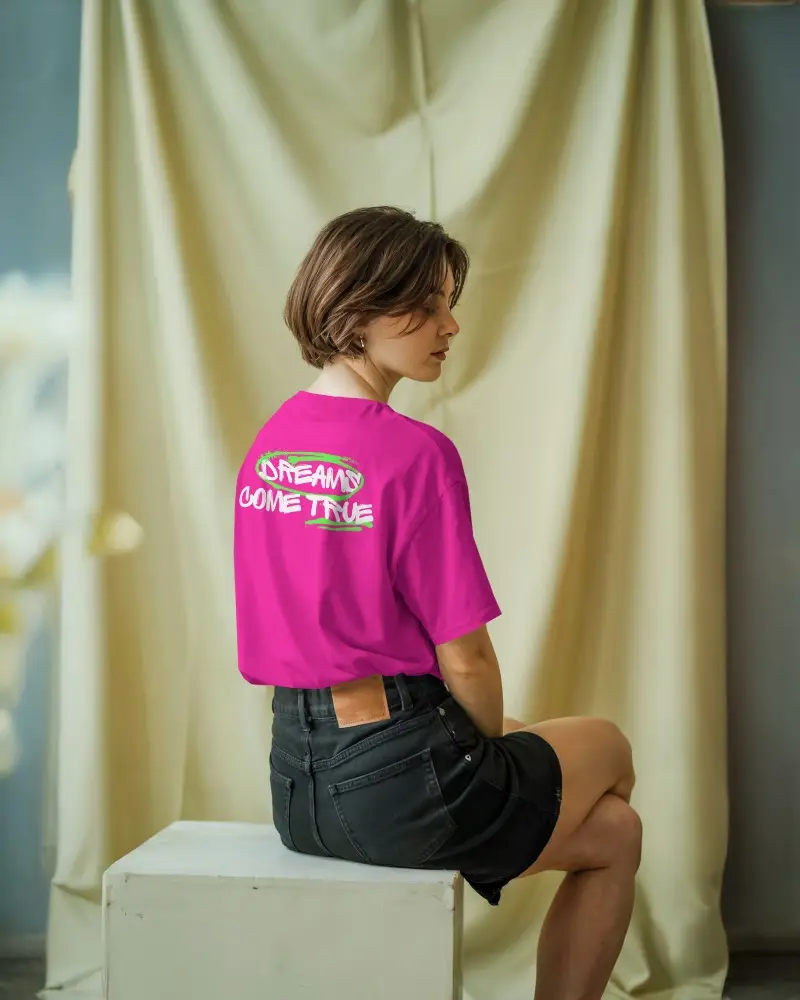 Tshirt Mockup Soft Curtain Background Female Model Seated On Box Looking Away Showing Back Design Subtle Lighting Studio Style