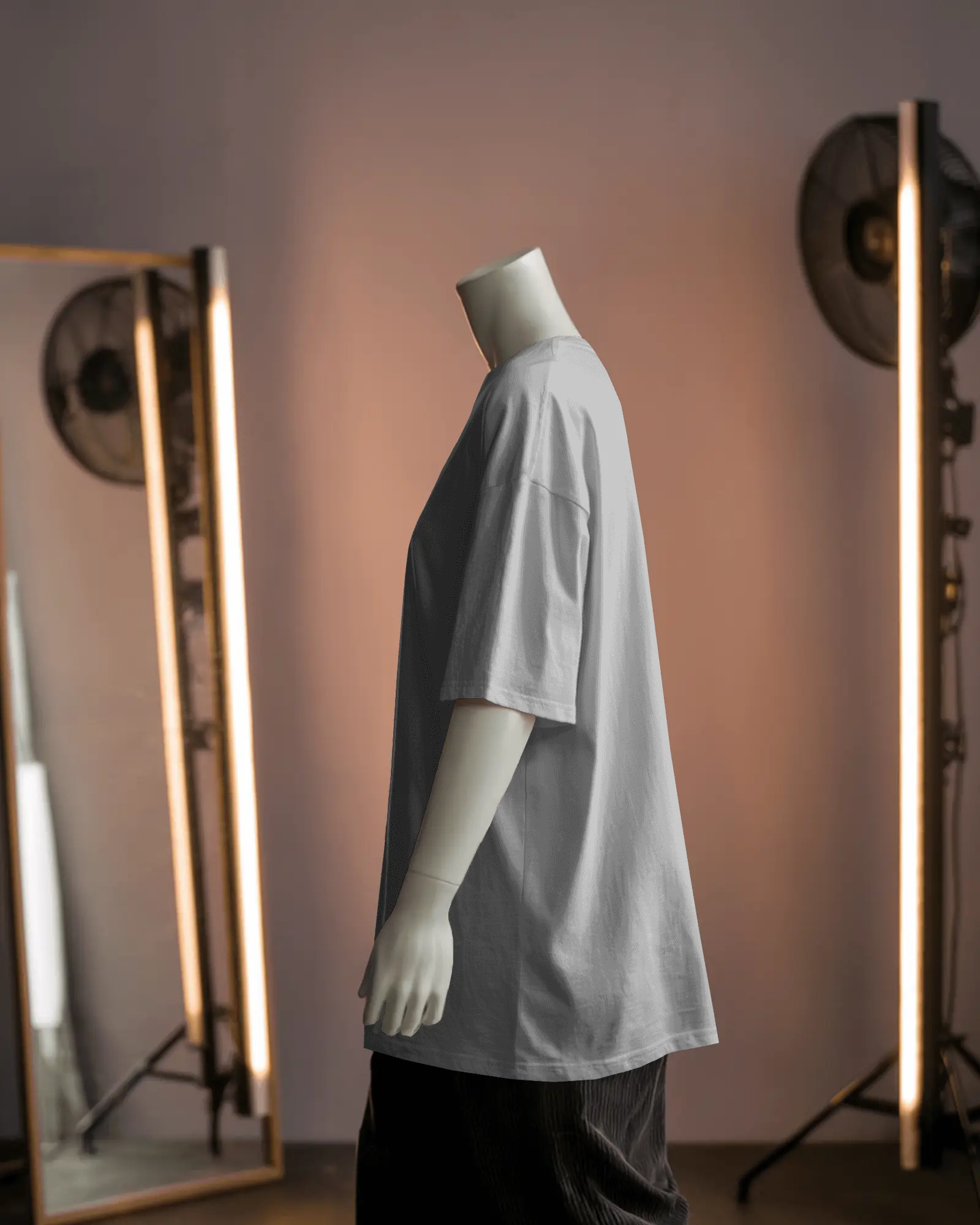 Side Profile Tshirt Mockup On White Mannequin With Loose Fit Shirt In Studio Setting With Softbox Lighting