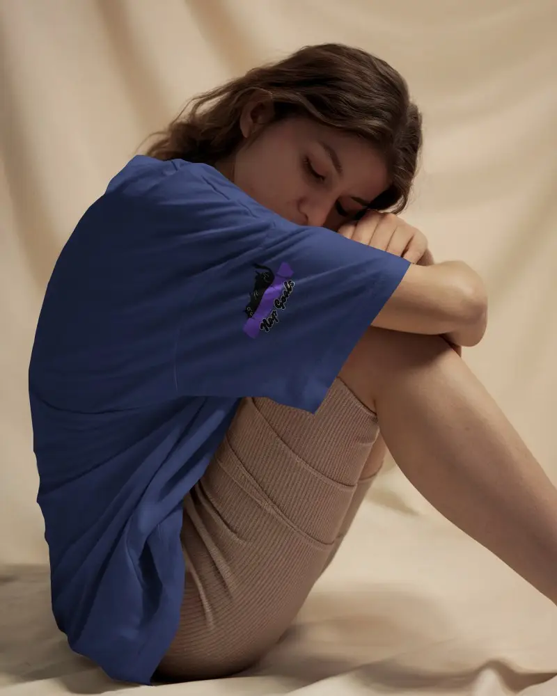 Tshirt Mockup Female Model Curled Up On Soft Beige Backdrop Wearing White Shirt In Cozy Lighting Serene And Intimate Atmosphere
