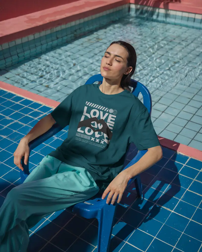 Poolside Tshirt Mockup Woman Sunbathing In Chair Blue Tiles Fresh Lighting Relaxed Summer Vibes