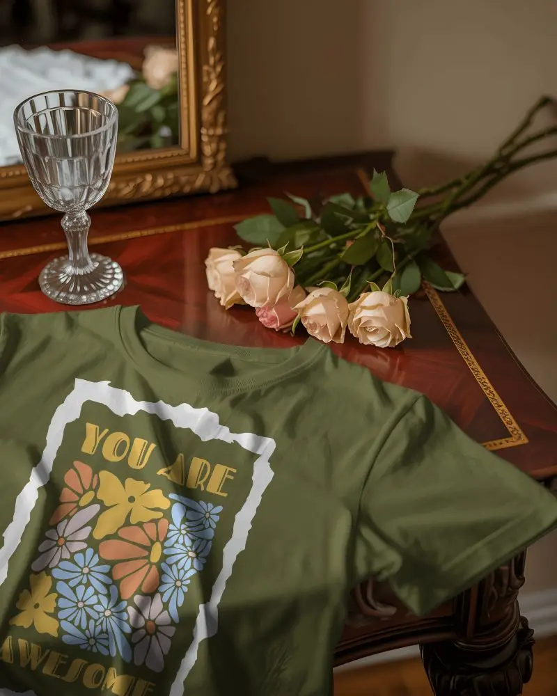 Elegant Vanity T Shirt Mockup Folded On Polished Wooden Table With Roses Mirror And Crystal Glass