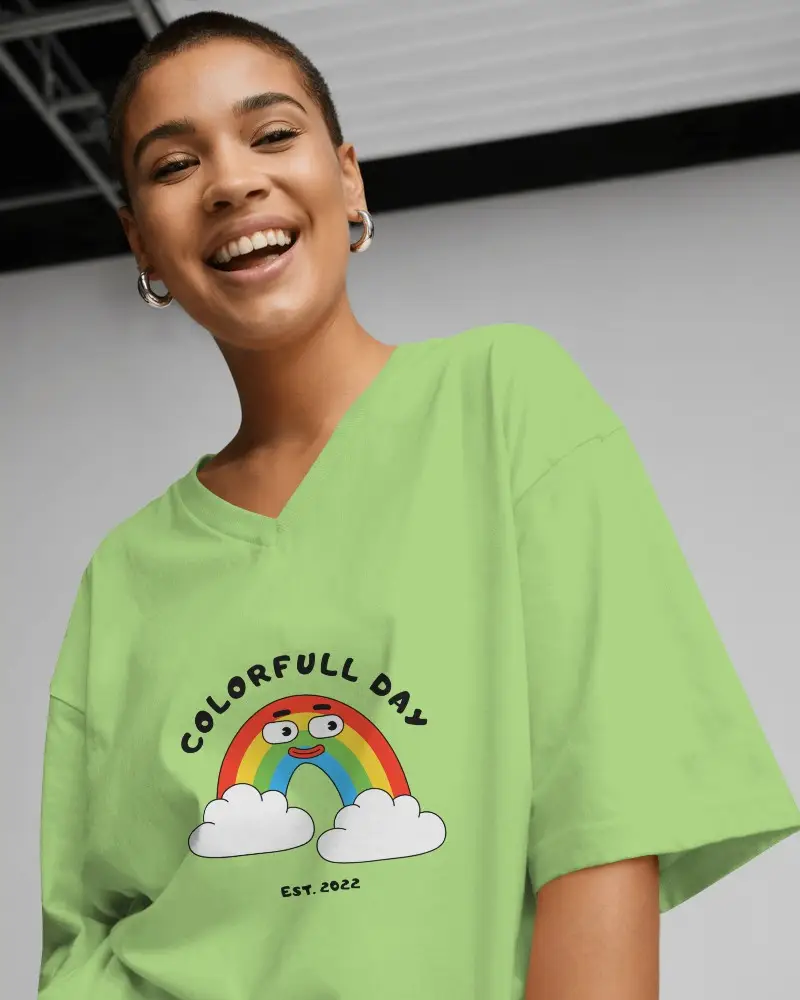 Happy Casual Look T Shirt Mockup Buzzcut Female Model Oversized Gray Tee Against Clean Neutral Wall
