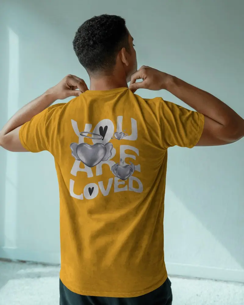 Indoor Natural Washed T Shirt Mockup Man Adjusting Collar In Soft Window Light Minimal Setting