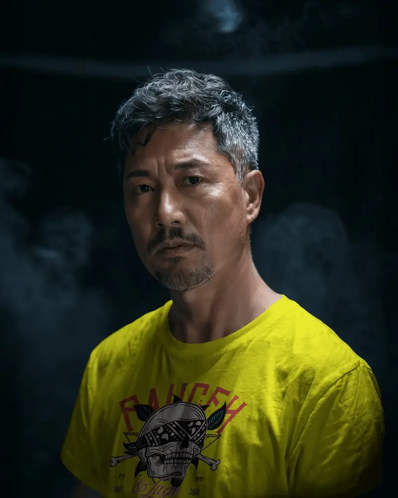 Cinematic Portrait T Shirt Mockup Asian Mid Age Male Model In Moody Low Light Setting