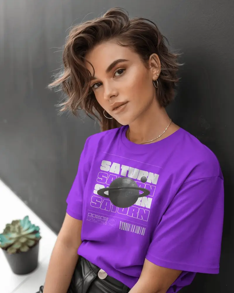 T Shirt Mockup Female Model Posing Confidently Against Dark Wall With Succulent In Frame
