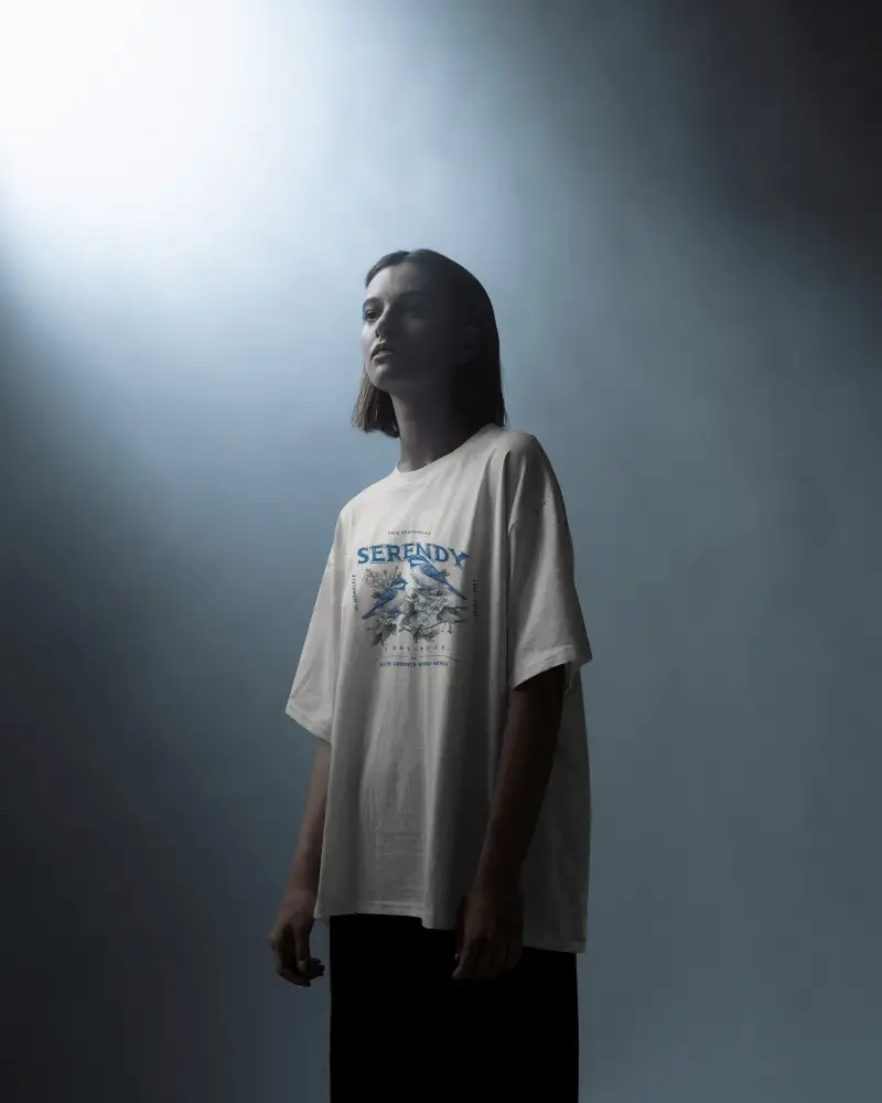 Dramatic Studio T Shirt Mockup Female Model In Soft Spotlight Wearing Artistic Graphic Design