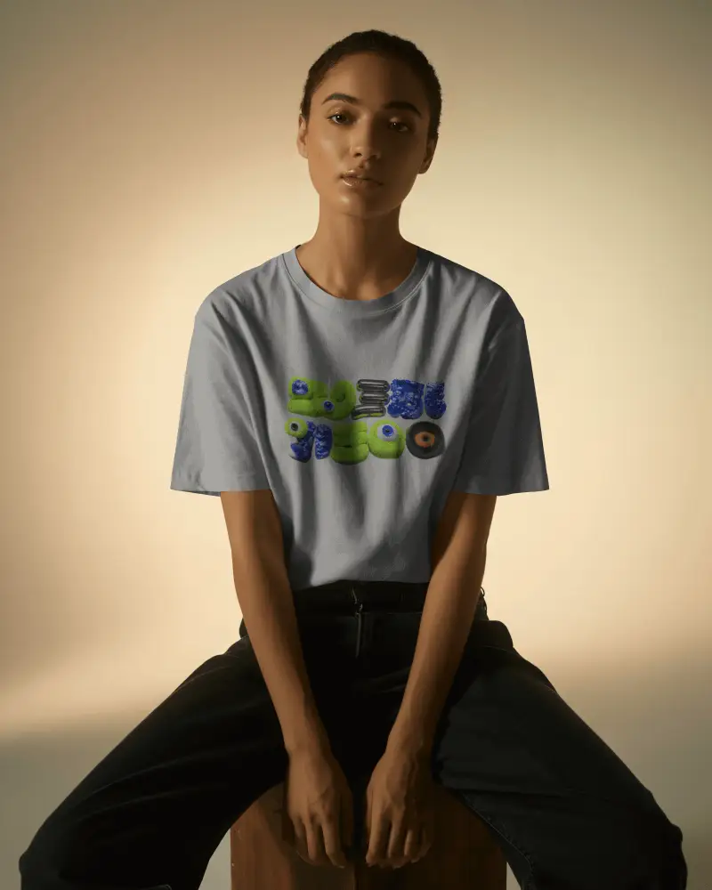 Seated Female Tshirt Mockup Natural Lighting Soft Expression Minimal Studio Clean Backdrop
