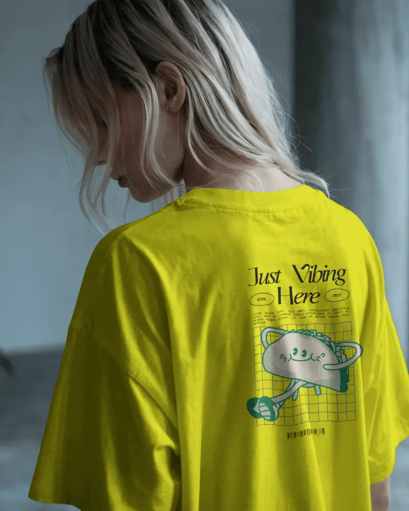 Moody Backview Tshirt Mockup Female Model In Loose Fit Against Minimal Studio Light