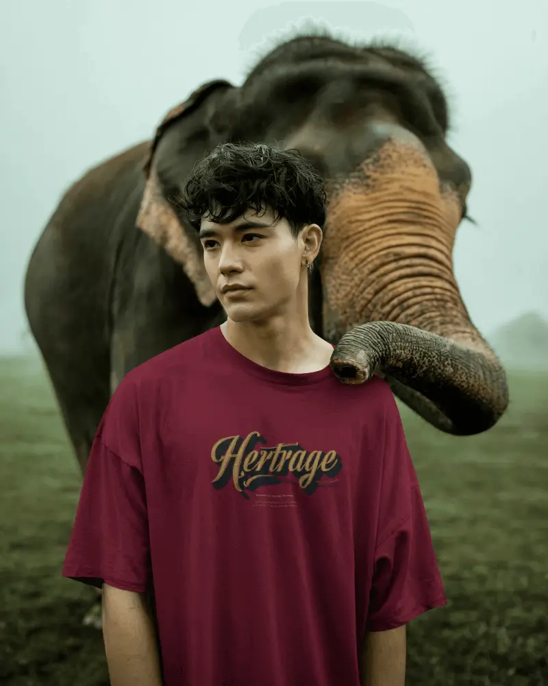 Lifestyle Tshirt Mockup Male Model Standing With Elephant In Green Field Nature Scene