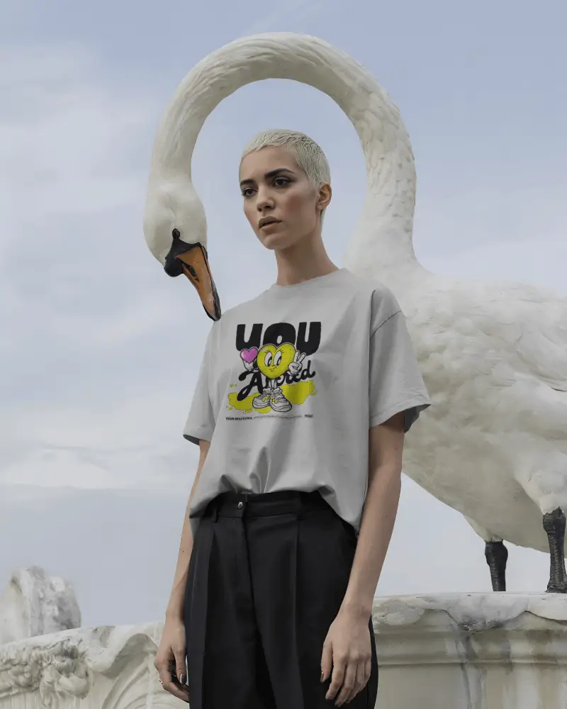Surreal Tshirt Mockup Female Model Standing With White Swan In Outdoor Setting
