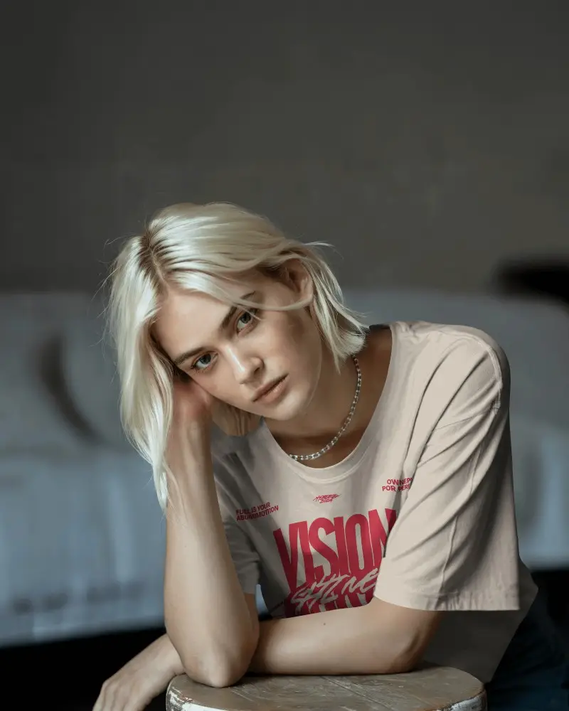 Moody Interior Tshirt Mockup Female Model With Blonde Hair In Soft Natural Light