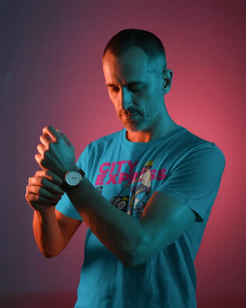 Cinematic Lighting Tshirt Mockup Male Model Adjusting Watch In Colorful Gradient Lighting