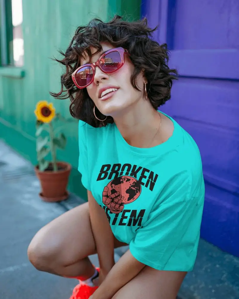 Playful Tshirt Mockup Female Model With Curly Hair And Red Sunglasses Colorful Street Scene
