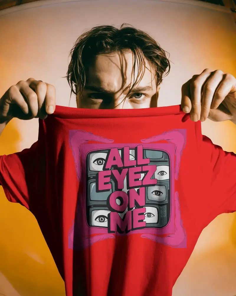 Dynamic Tshirt Mockup Male Model Holding Shirt Up With Intense Expression In Warm Light