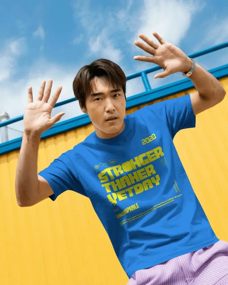 Modern Fashion Tshirt Mockup Male Model Dynamic Pose Under Blue Sky And Bright Yellow Wall