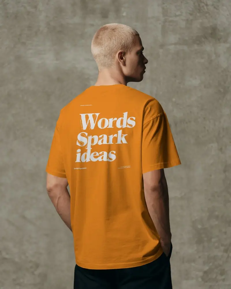 Textured Wall Back View T Shirt Mockup Male Model In Raw Industrial Studio Setting