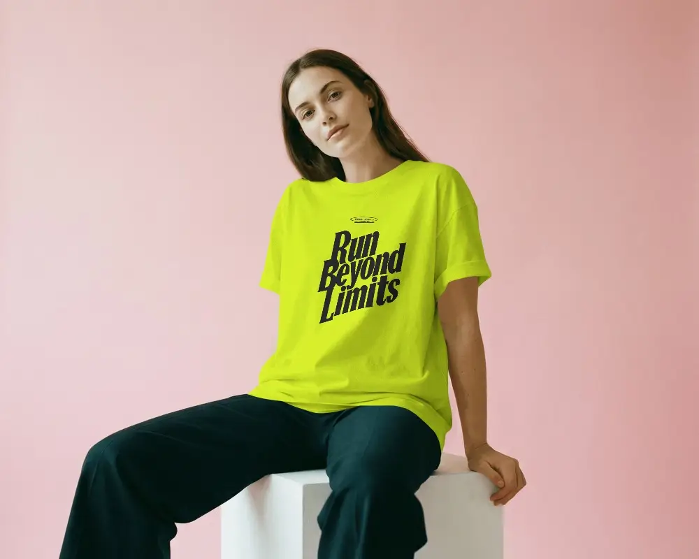 Stylish Tshirt Mockup On Woman Model Seated On Block With Pastel Pink Backdrop