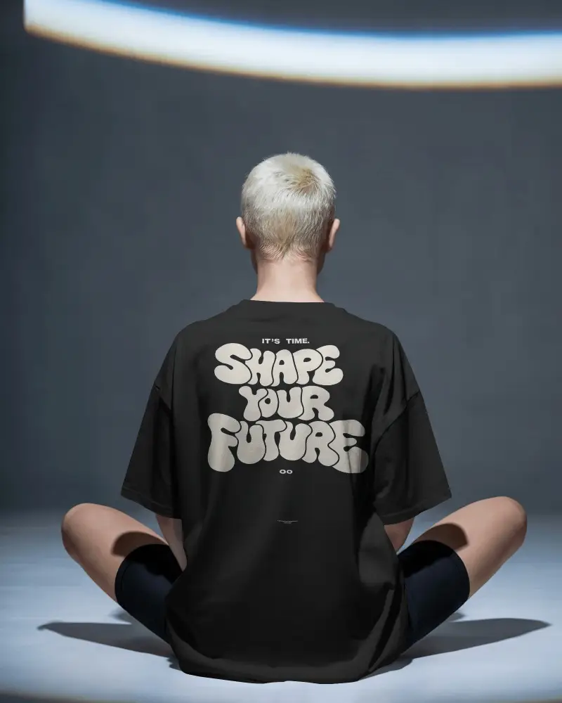 Back View T Shirt Mockup Male Model Seated Cross Legged Soft Studio Lighting Cinematic Mood