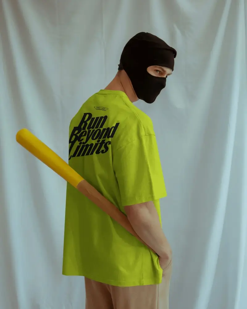 Back View T Shirt Mockup Male Model Standing With Bat Minimal Backdrop Editorial Style