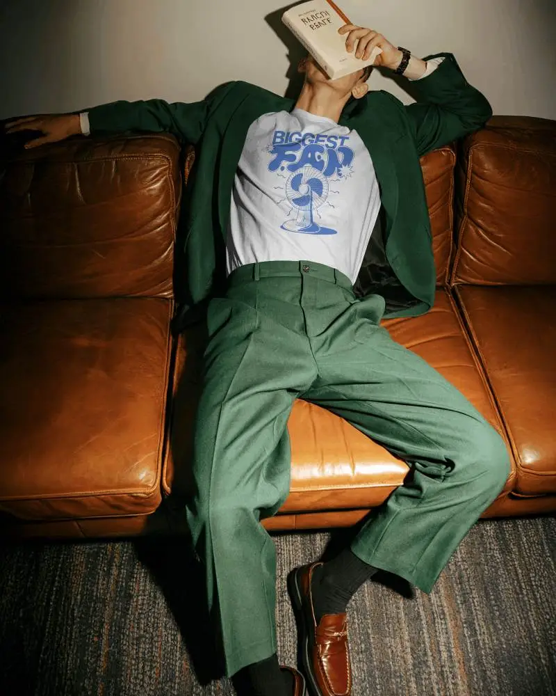 Lifestyle T Shirt Mockup Male Model Relaxing On Leather Sofa Editorial Indoor Style