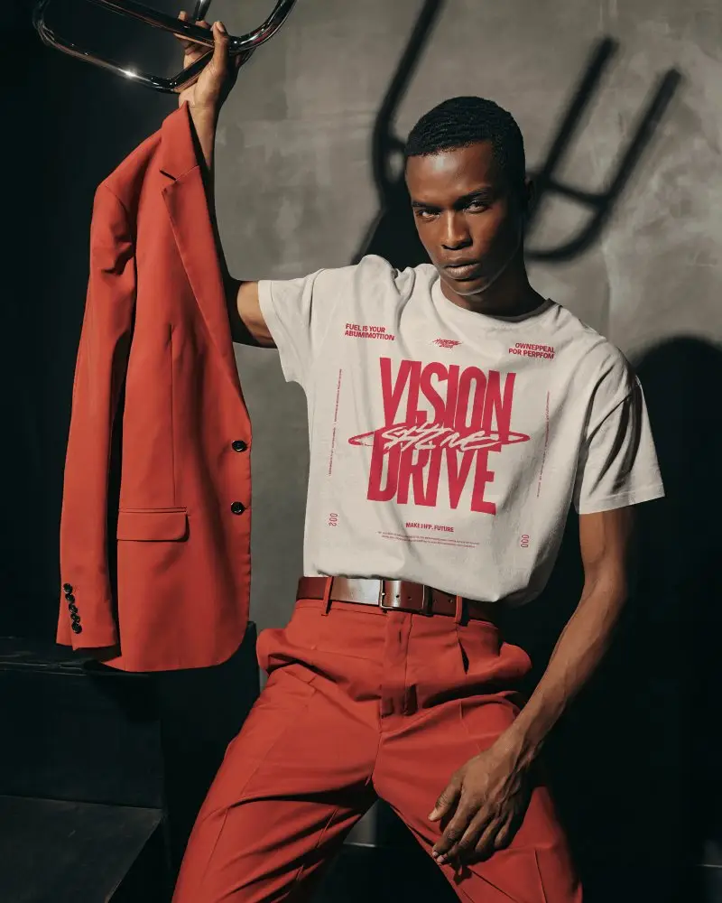 Editorial T Shirt Mockup Male Model Holding Jacket Bold Fashion Studio Lighting