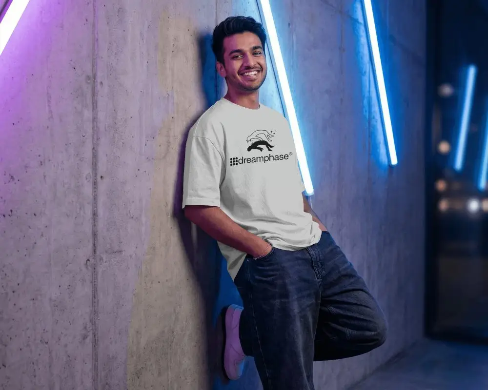 Casual Loose Fit Tshirt Mockup For Men Standing Against Textured Wall With Neon Lights