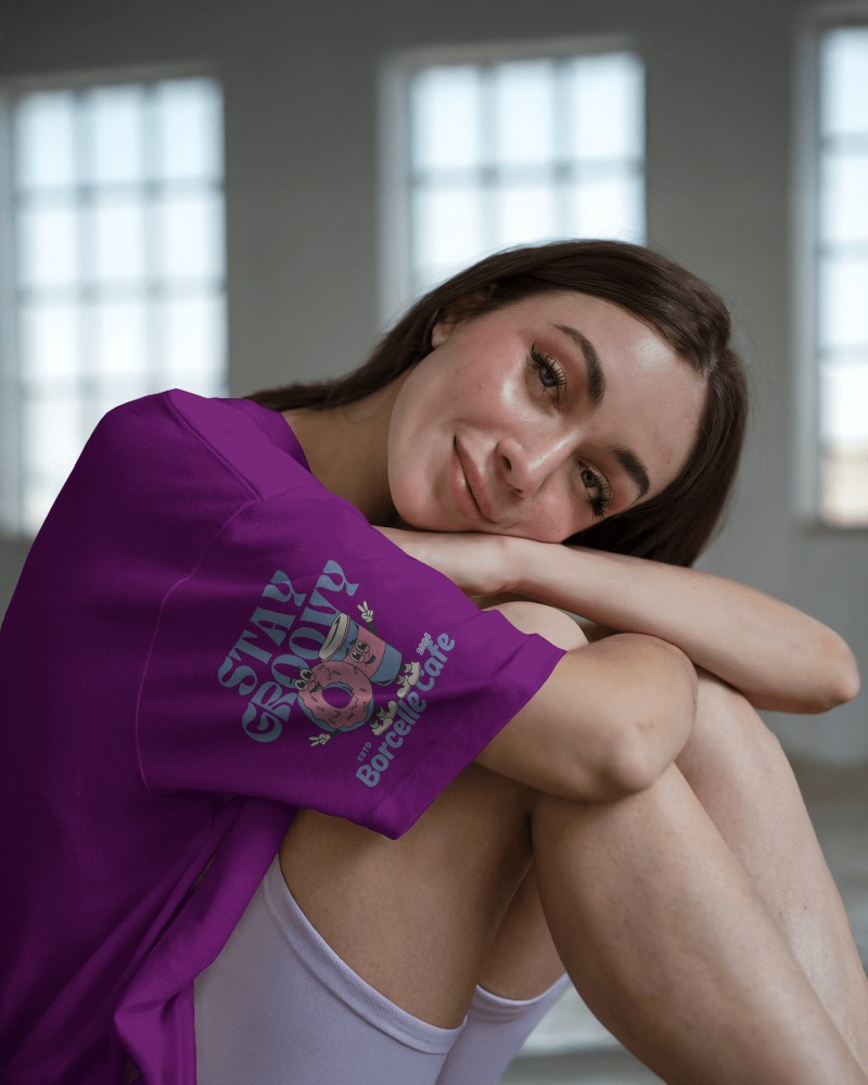Soft Light T Shirt Mockup Female Model Smiling Gently In Relaxed Seated Pose With Natural Window Light 0587