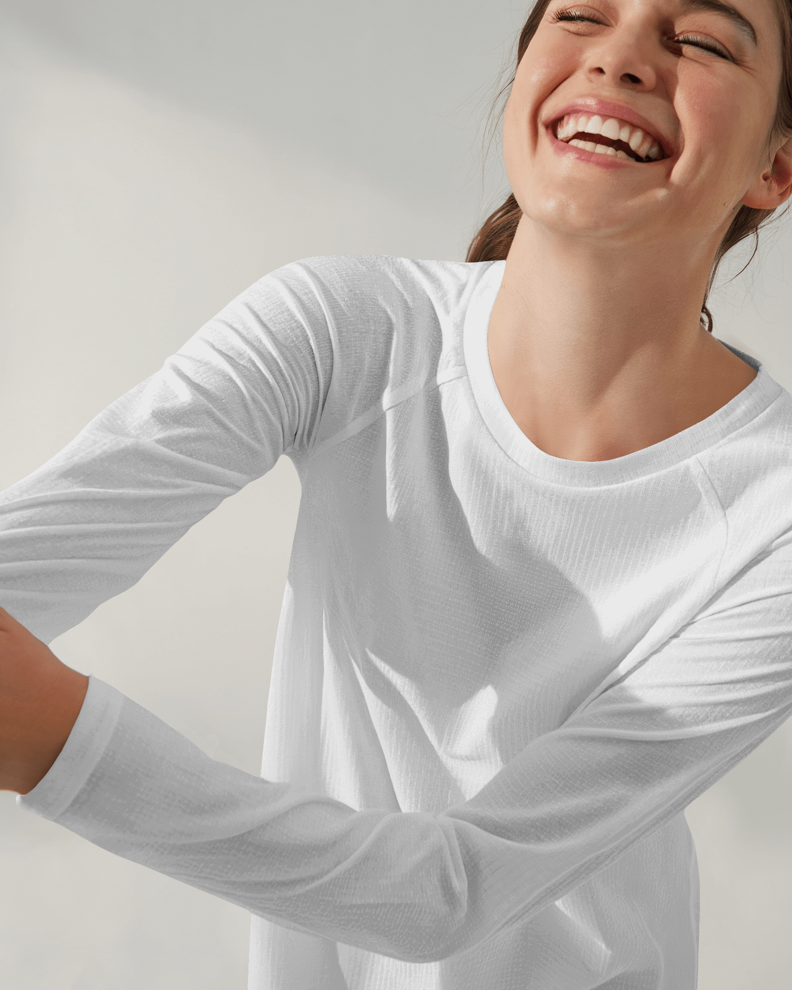 Blank White Long Sleeve T Shirt Mockup Woman Smiling Playful Pose Natural Lighting Minimalist Background Modern And Fresh Look 0850