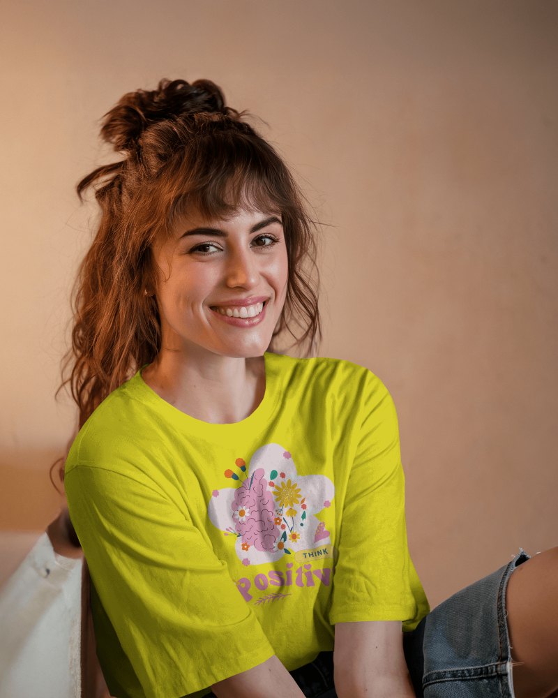 Casual Indoor T Shirt Mockup Female Model Smiling In Relaxed Pose Wearing White Round Neck Tee Against Warm Toned Background Natural And Friendly Vibe 0900