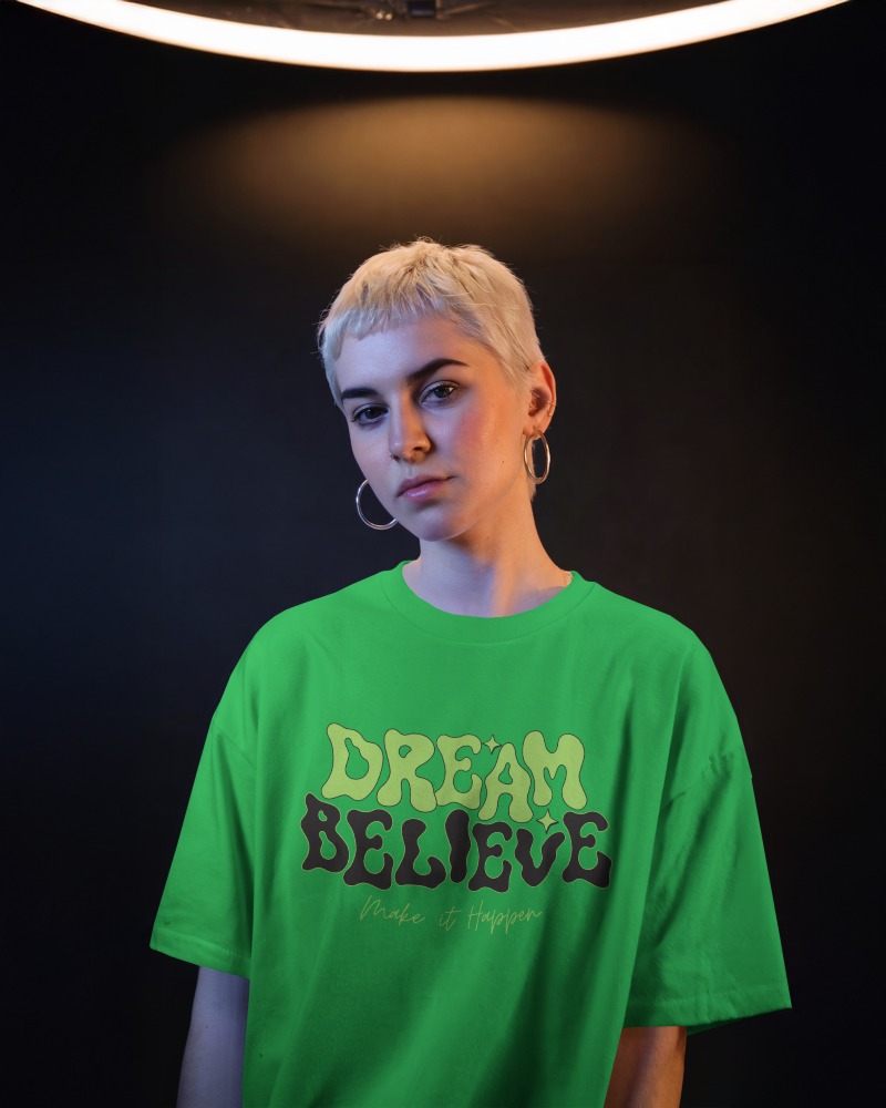 Moody Studio T Shirt Mockup Female Model Under Halo Lighting With Serious Expression Dark Background Contrasting Glow Aesthetic 0916