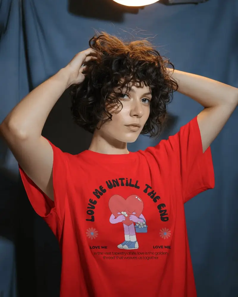 Moody Studio T Shirt Mockup Curly Haired Female Model In Overhead Lighting Against Blue Backdrop
