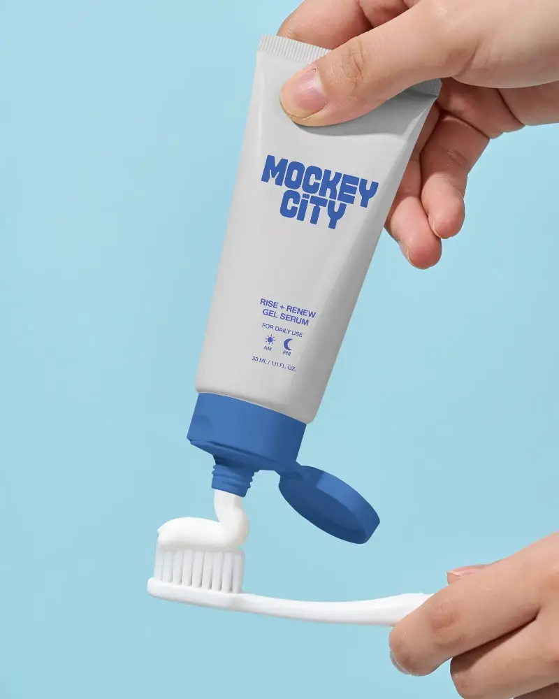 Premium Toothpaste Tube Mockup With Open Cap And Cream On Toothbrush Hand Holding