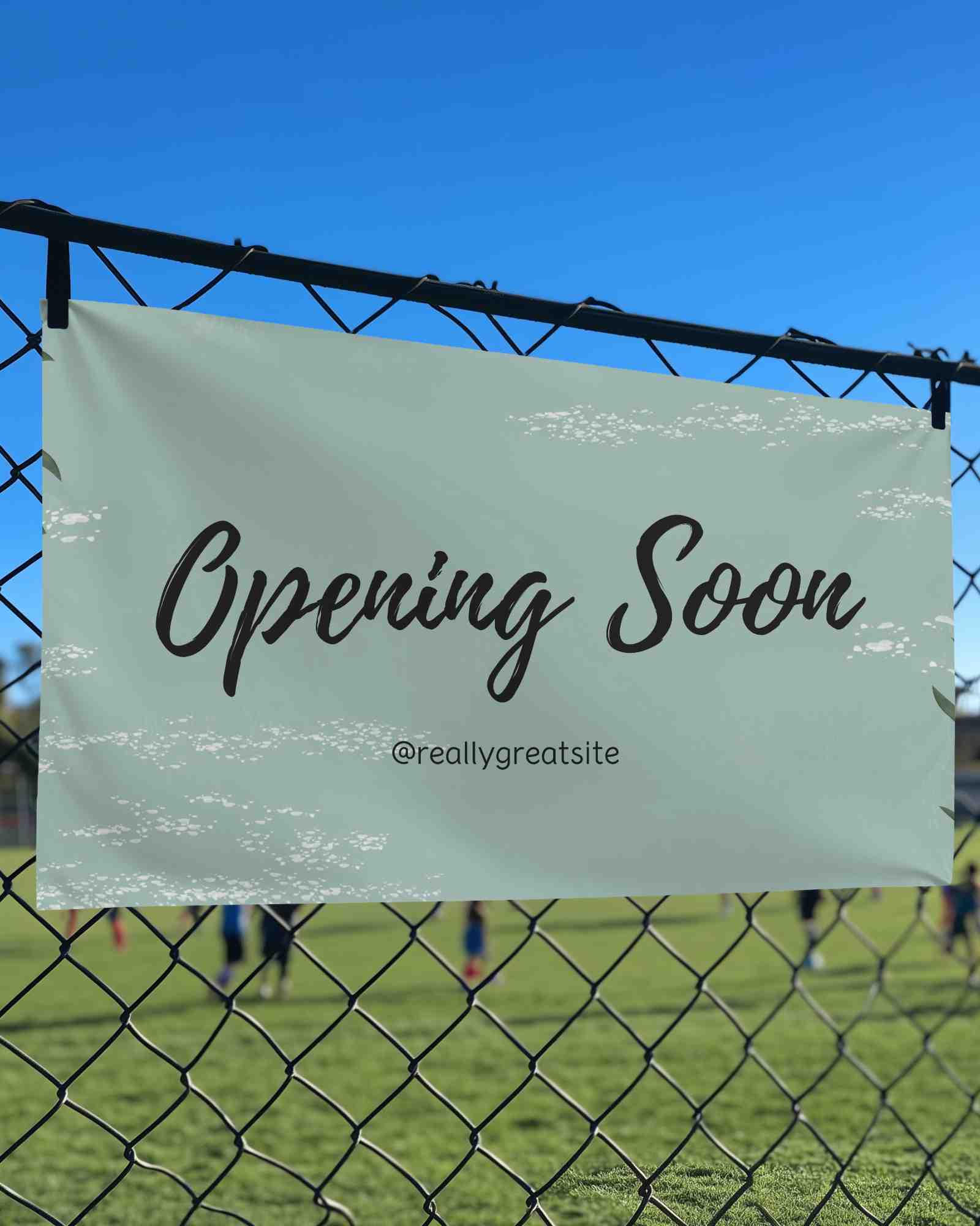 Sports Field Fence Banner Mockup Outdoor Advertising On Metal Mesh With Clear Blue Sky And Players In Background