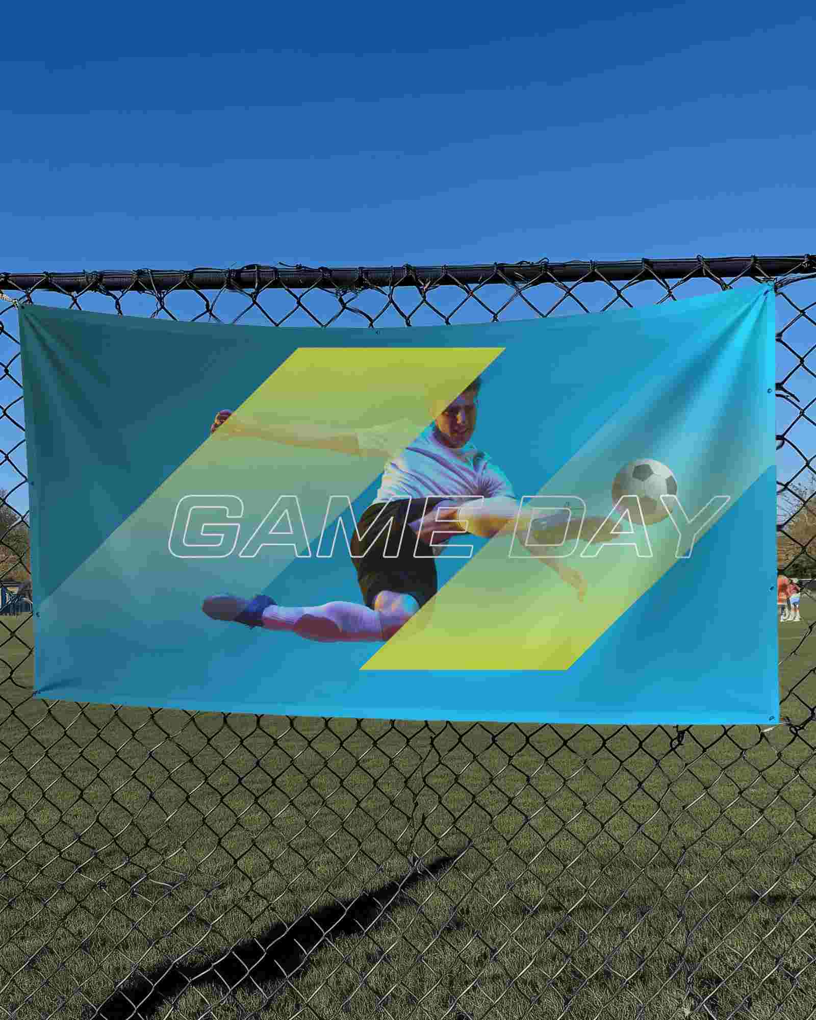Outdoor Banner Mockup Hanging On Chain Link Fence Under Clear Blue Sky Sports Field Background Sunny Day Display