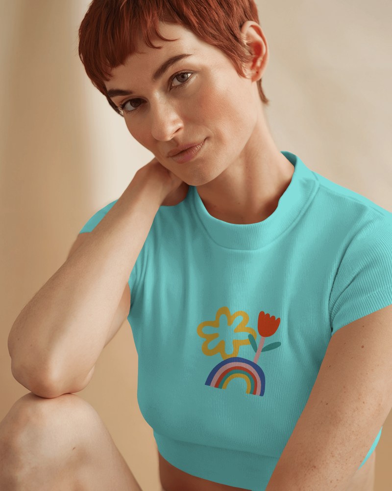 Soft Aesthetic Crop Top Mockup Female Model In Relaxed Pose With Minimalist Floral Rainbow Print