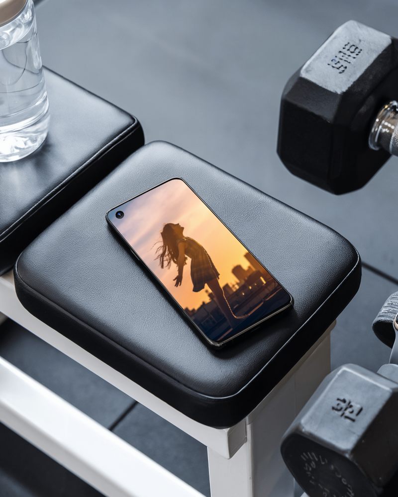 Gym Bench Smartphone Mockup On Workout Equipment With Dumbbells And Water Bottle