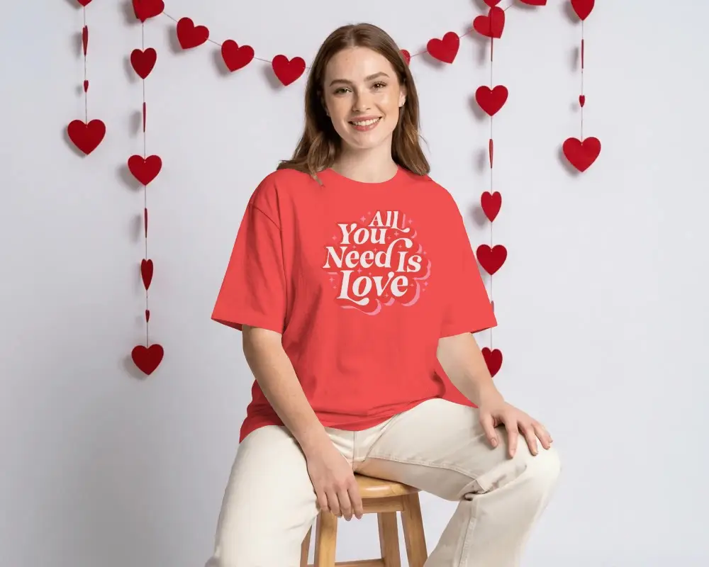 Smiling Female Model Wearing Blank Tshirt Mockup With Valentine Themed Heart Garland Background
