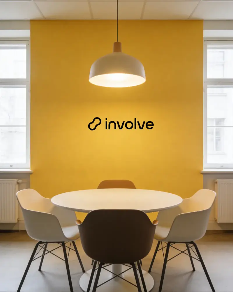 Bright Indoor Office Space With Simple Furniture Large Windows And Yellow Accent Wall Logo Mockup