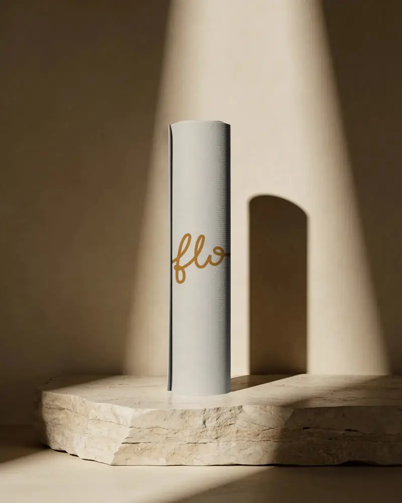 Rolled Yoga Mat Mockup On Stone Pedestal With Warm Spotlight And Minimal Wellness Studio Scene