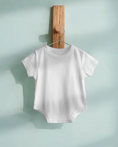 Baby Tee Mockup Infant Bodysuit Hanging On Wooden Hook With Soft Pastel Wall Background